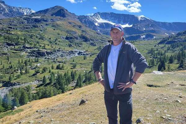 Mark Donnelly standing on a hill that outlooks a valley