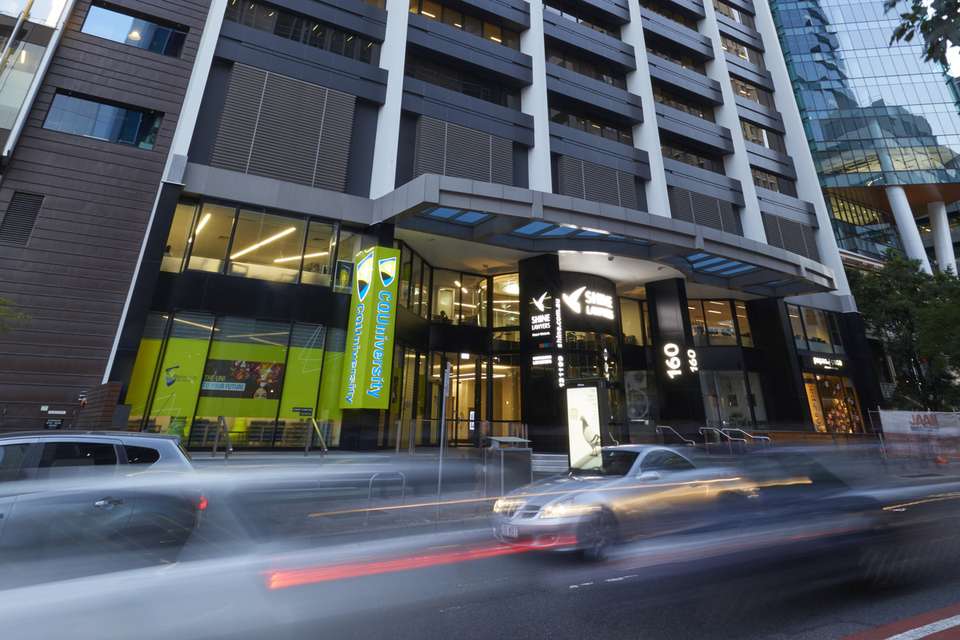 A low angle view of the exterior of the CQU Brisbane City Campus high-rise building in Queensland