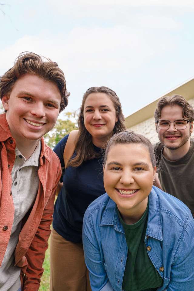 Group of students on campus at CQU smiling and looking at the camera.