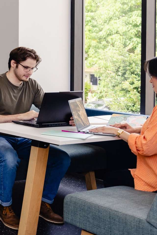 CQU students study together at tables in an open plan area on campus.