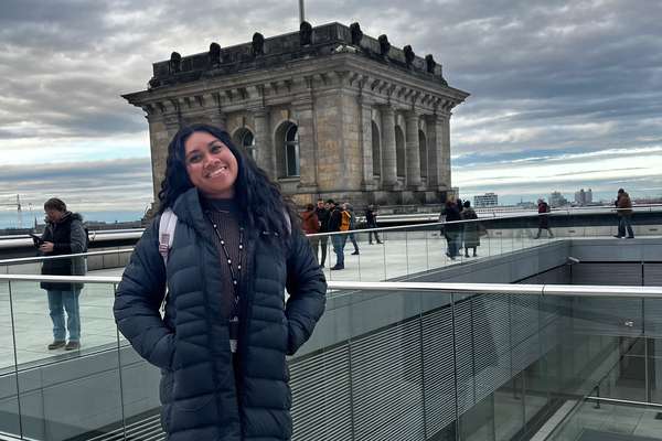 Susan Lafaele smiling and standing in front of building