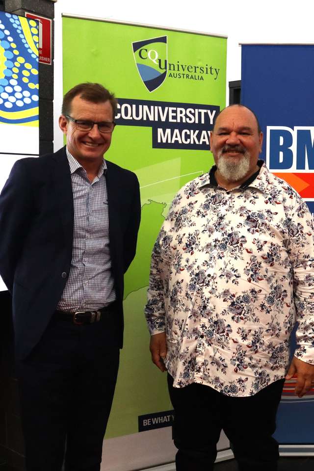 Mr Steve Johnson (BMA), Prof Adrian Miller (CQU) and Prof Grant Stanley (CQU) standing together infront of a CQU and a BMA pull up banner