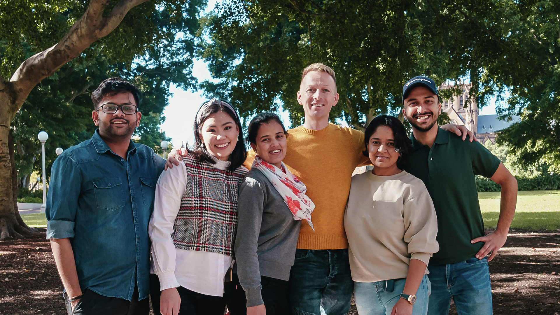 Six CQU students stand in a courtyard smiling at the camera.