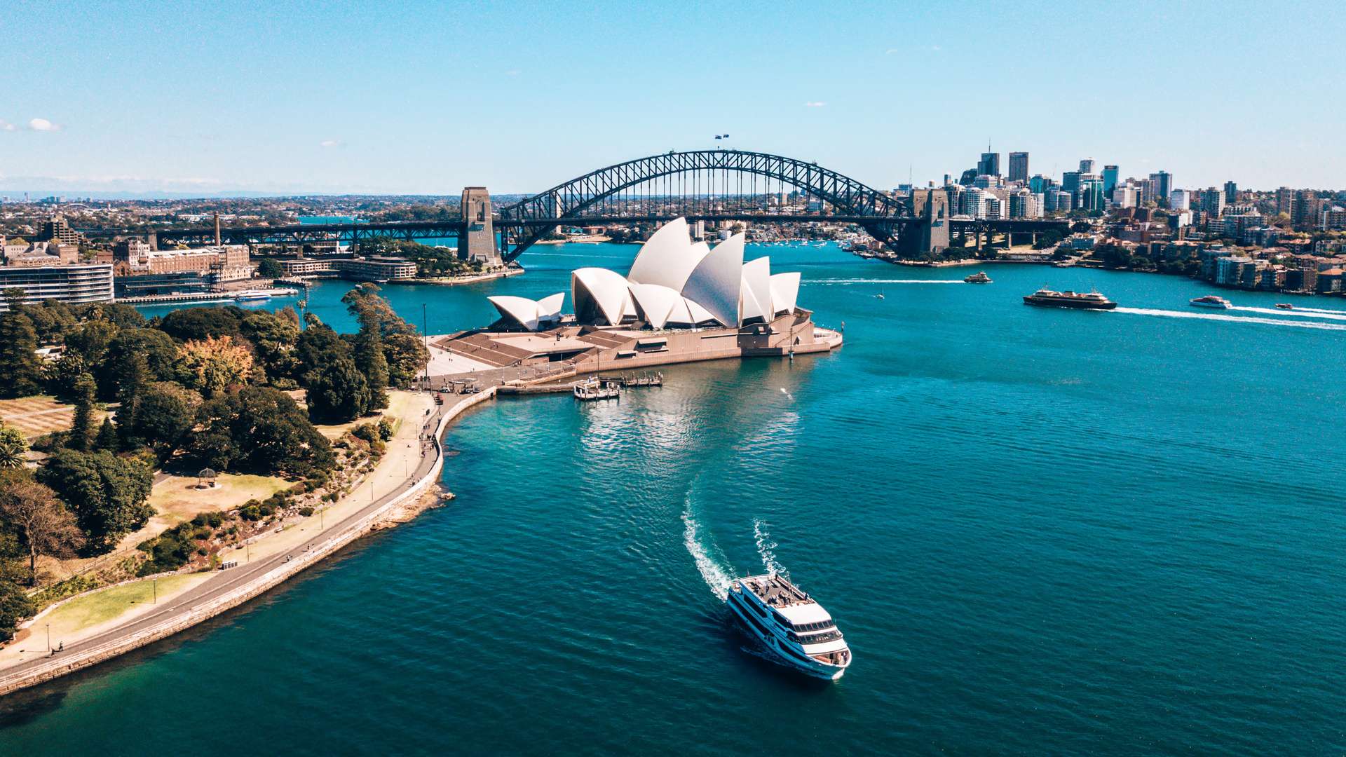 Aerial view of the Sydney Opera House and Harbour Bridge near Sydney's business center around the harbour.