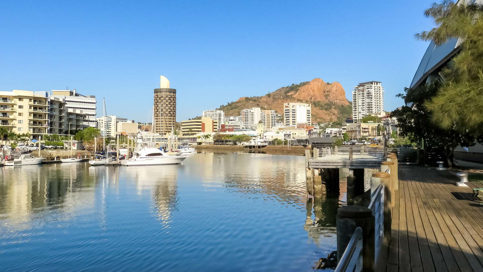 Ross River flowing through Townsville, Australia, with Castle Hill in the background.